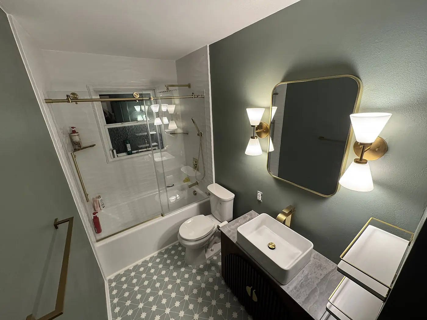 Sage & Brass Guest Bath — guest bathroom refresh with sage green walls, brushed brass fixtures, a vessel sink vanity, patterned floor tile and glass tub enclosure, installed by Revive Bath Solutions in Flint, TX
